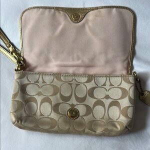 Coach Tan and Gold Clutch Wristlet, Width 8 Inches, Length 5 Inches.